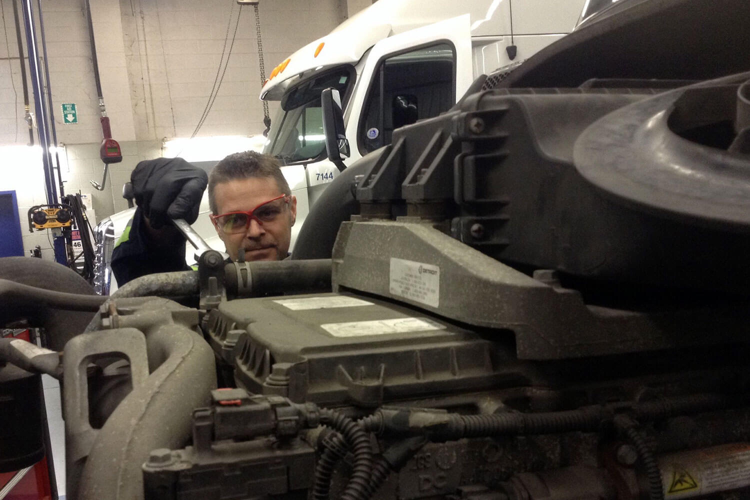 Mechanics working on truck engine