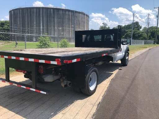 Autow-Used-Truck-04 Flatbed in a dirt road